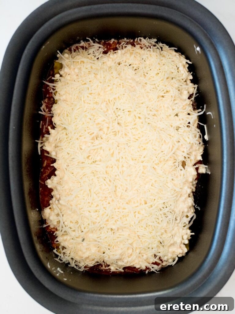 shredded mozzarella over cheese mix in crockpot