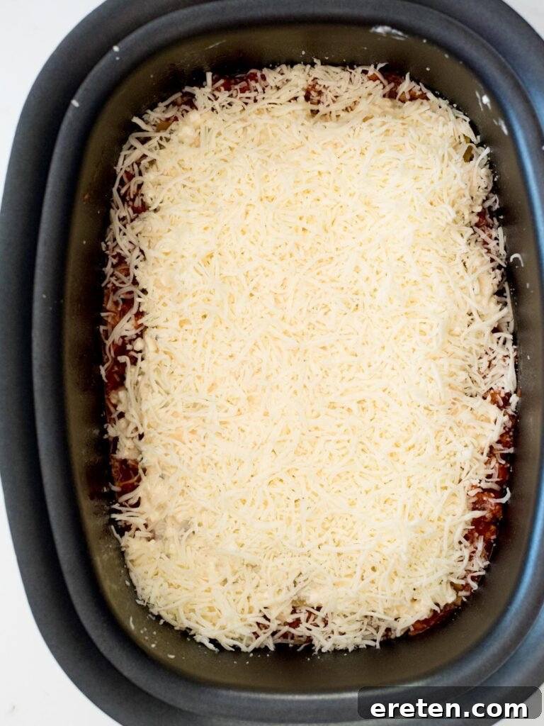 shredded mozzarella over cheese mix in crockpot
