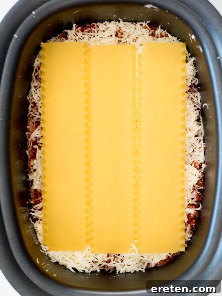 noodles over shredded mozzarella in the crockpot