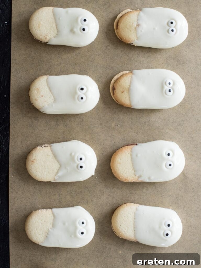 Candy eyes placed on almond bark dipped cookies