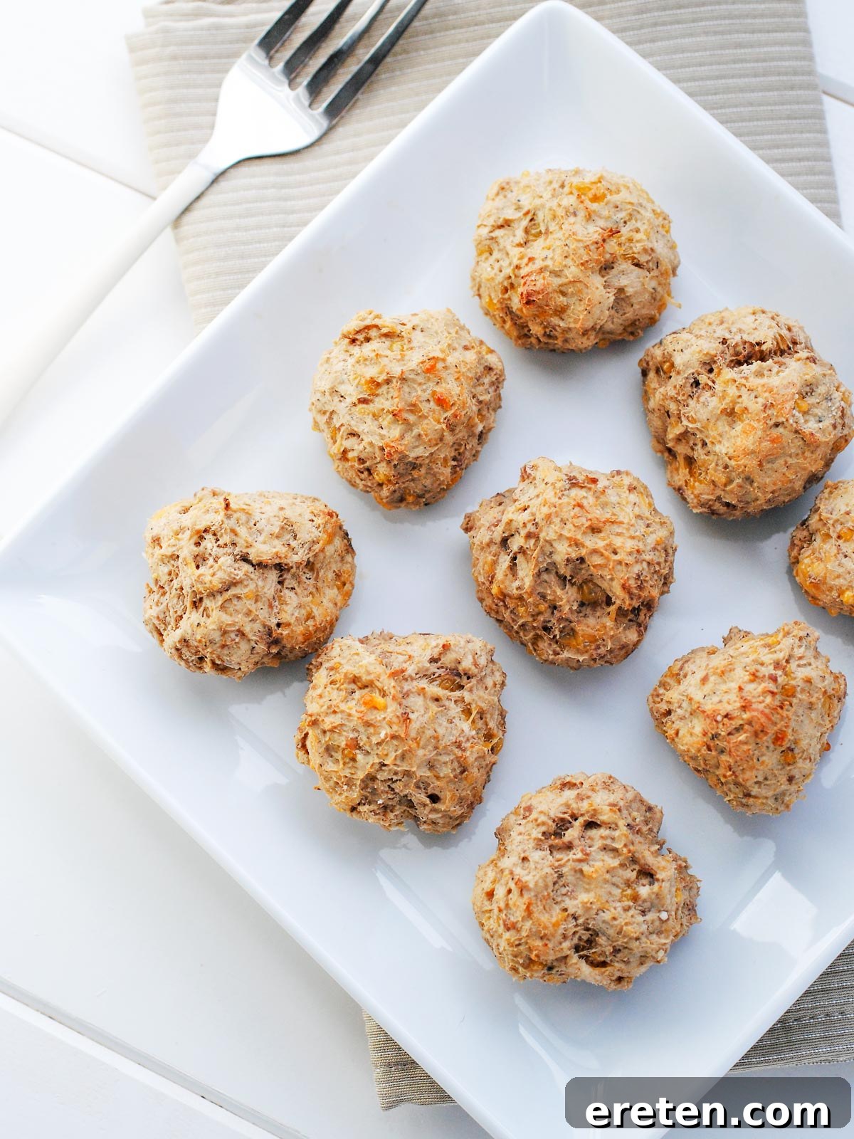Bisquick Sausage Ball Bliss 2 Lighter sausage balls on a white plate, showcasing a healthier alternative to a classic snack.