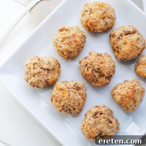 lighter sausage balls on a white plate