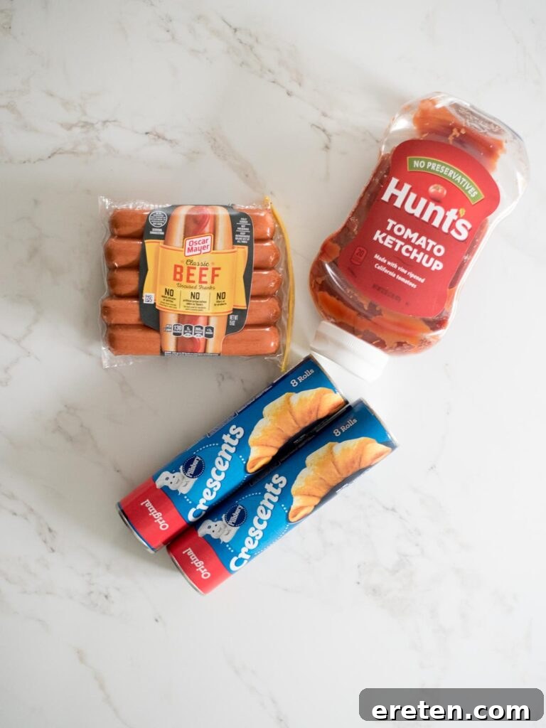 Halloweenie Mummies 3 Three essential ingredients for mummy pigs in a blanket: crescent roll dough, hot dogs, and ketchup