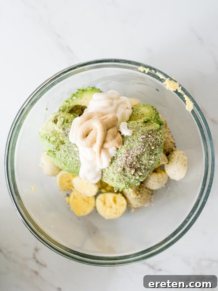 Dijon mustard added to the creamy mixture of avocado, mayonnaise, seasonings, and egg yolks.