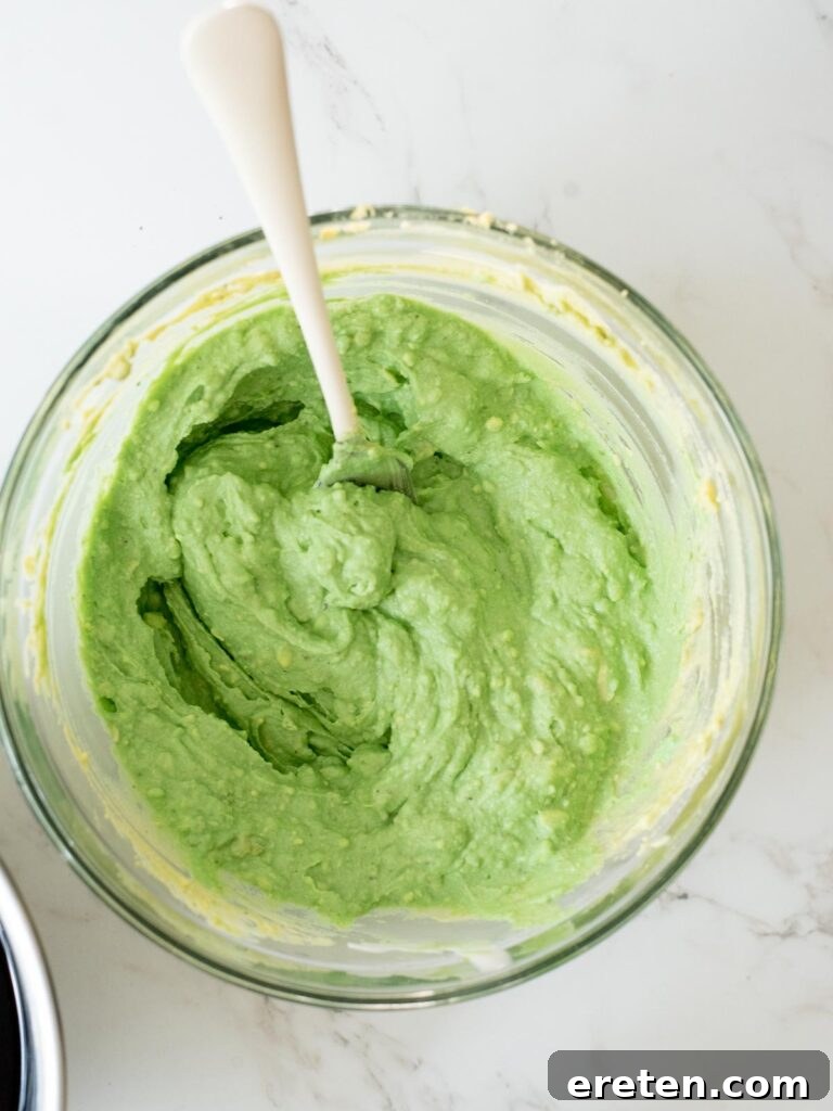 The egg filling completely mixed with green food coloring, achieving a vibrant, spooky hue.