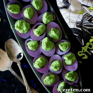 purple and green deviled eggs on a platter