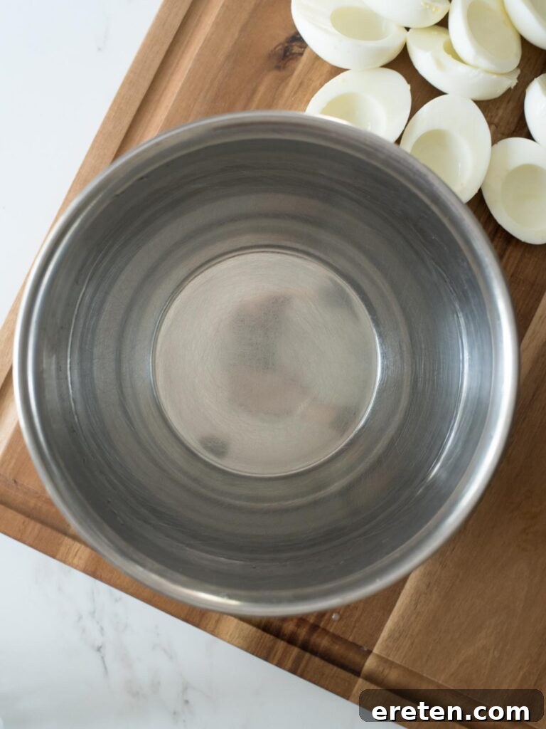 A mixing bowl filled with water, prepared for adding food coloring to create the dye bath.