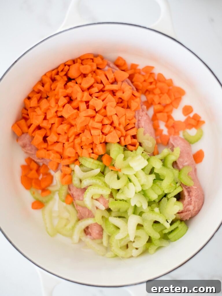 Quick and Comforting Pasta Fagioli 5 carrots and celery added to italian sausage in the dutch oven