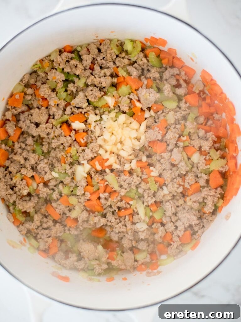 Quick and Comforting Pasta Fagioli 7 garlic added to dutch oven with sausage mix