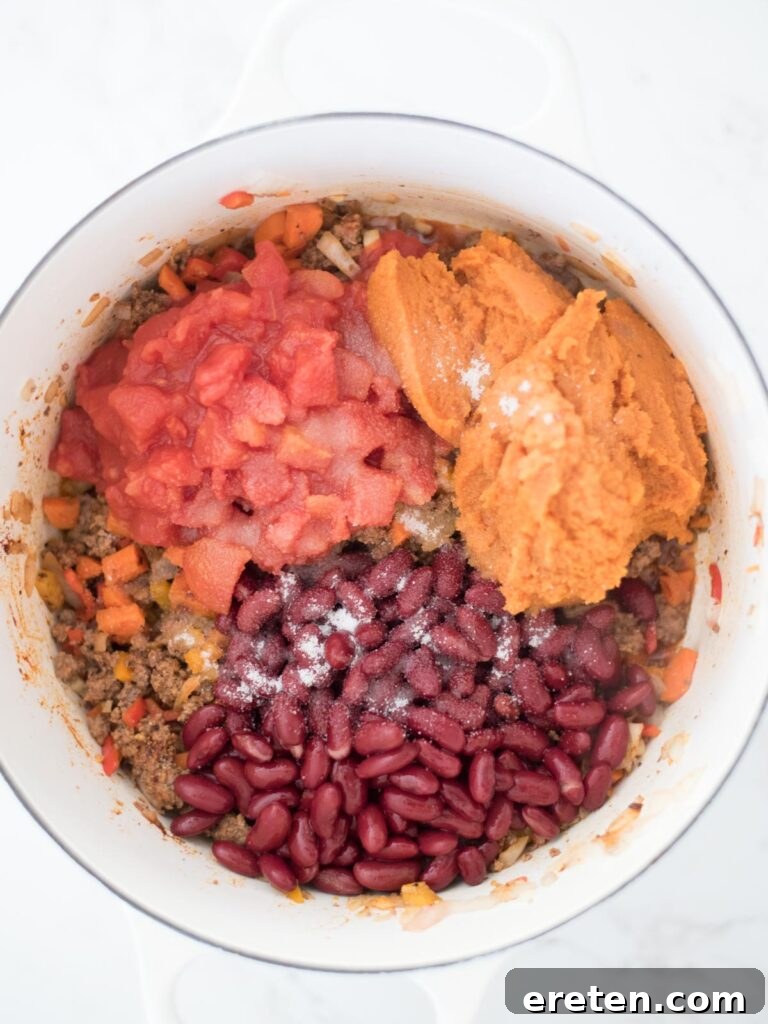 A sprinkle of sugar added to the pot, enhancing the natural sweetness and balancing the acidity of the chili ingredients.