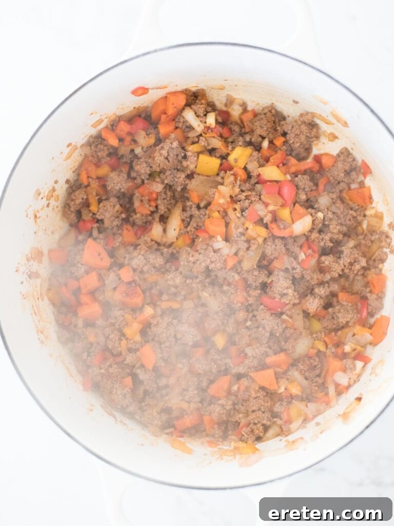 A close-up view of the perfectly cooked vegetable and beef mixture, fragrant and ready for the next additions.